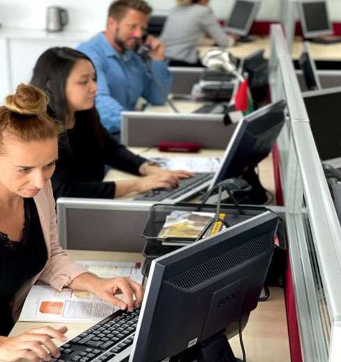 three people working using their computer desktop