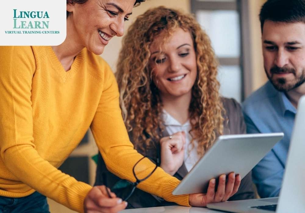 Three people are discussing while looking at a tablet